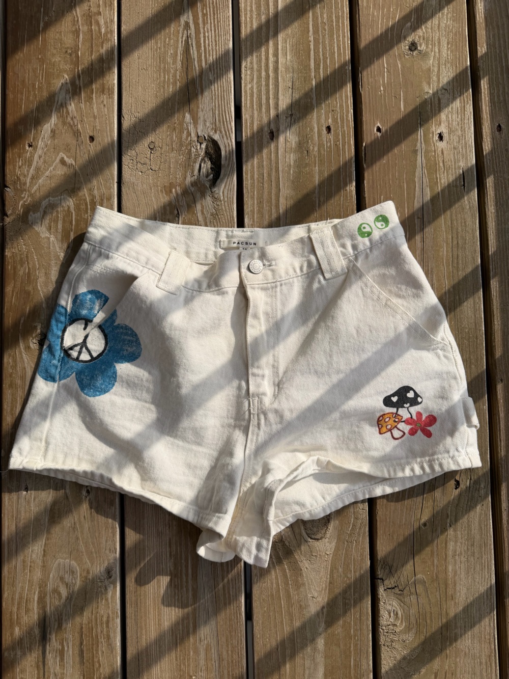 PacSun Cream shorts with various graphics